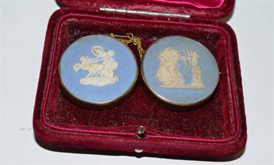 Lot 73 - Two Wedgwood Jasperware brooches in yellow metal mounts