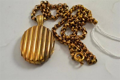 Lot 77 - A locket, circa 1900, engraved '15ct' on belcher chain