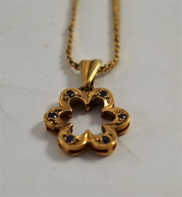 Lot 83 - A 9ct gold sapphire floral pendant on chain