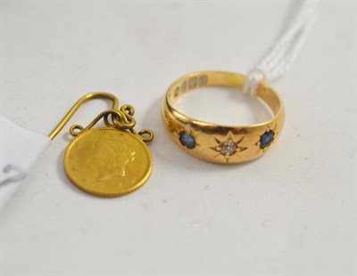 Lot 95 - A diamond and sapphire ring and a $1 coin mounted on a stick pin