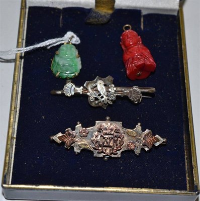 Lot 106 - A jade Buddha charm, two bar brooches and another Eastern charm