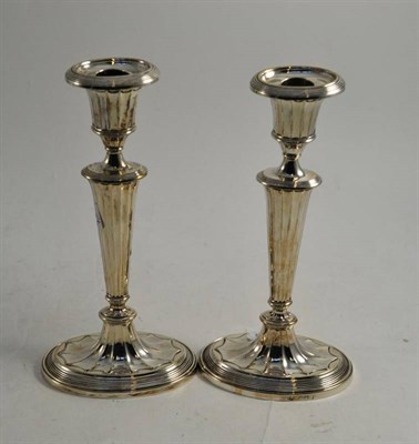 Lot 131 - A pair of late Victorian silver candlesticks in Neo-Classical style, London 1897