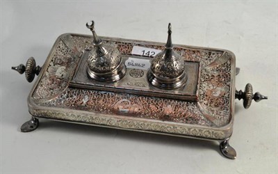 Lot 142 - An Indian silvered metal inkstand decorated in low relief with figures and foliage, 30cm