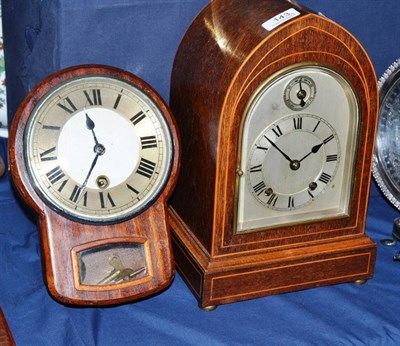 Lot 143 - An Edwardian oak lancet cased mantel clock, the spring driven movement striking on two gongs,...