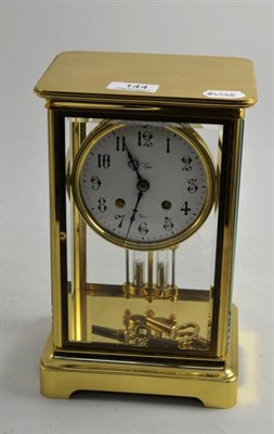 Lot 144 - A brass four glass clock with mercury compensating pendulum, striking on a bell, 27cm high