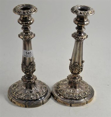 Lot 145 - A pair of George IV silver candlesticks with acanthus sheathed stems, Sheffield 1824, loaded, 28cm