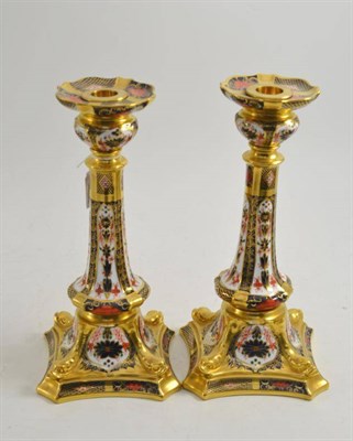 Lot 197 - A pair of Royal Crown Derby 1128 Imari pattern candlesticks, 27cm, boxed