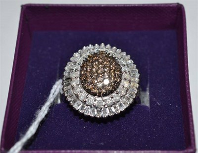 Lot 203 - A cognac and white diamond cluster ring