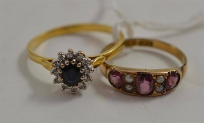 Lot 215 - An 18ct gold sapphire and diamond cluster ring and a garnet and seed pearl ring (2)