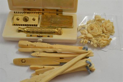 Lot 228 - An ivory floral brooch (a.f.), nine ivory sticks and an ivory razor case