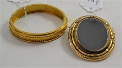 Lot 229 - A Victorian silver gilt bangle and a locket brooch (2)