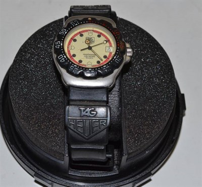 Lot 236 - A mid-size Tag Heuer watch with box and papers