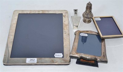 Lot 262 - Three silver photograph frames, a silver scent bottle and a pepperette