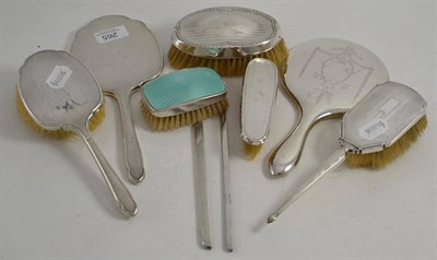 Lot 265 - A silver backed three piece dressing table set, four similar items and two comb backs