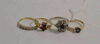 Lot 322 - A 9ct gold iolite ring, a sapphire and CZ ring stamped '750' (faintly), a 9ct gold garnet set...