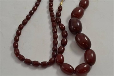 Lot 343 - Two cherry amber bead necklaces