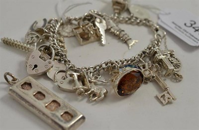 Lot 345 - A silver charm bracelet and a silver ingot