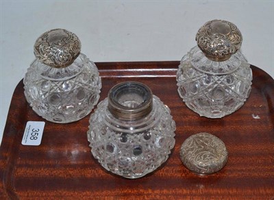 Lot 358 - Three silver topped glass scent bottles