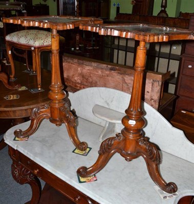 Lot 489 - A pair of Victorian walnut tripod tables with foliate carved shaped square tops