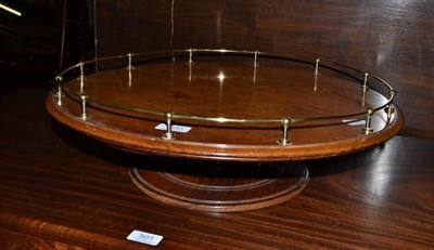 Lot 500 - A walnut Lazy Susan with brass gallery