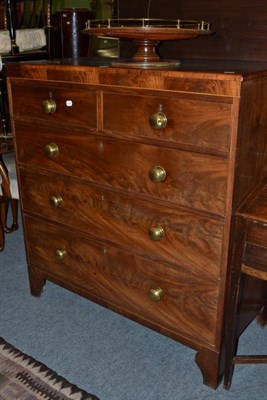 Lot 501 - An early 19th century mahogany four height chest with brass knob handles