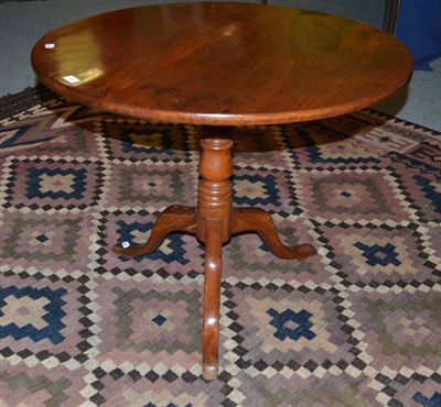 Lot 506 - A 19th century mahogany circular tilt top table