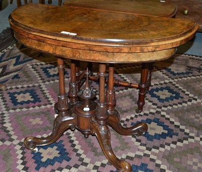 Lot 507 - A Victorian figured walnut demi-lune swivel top card table