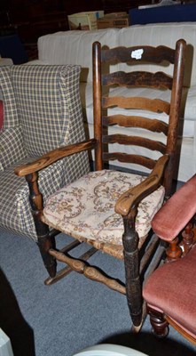 Lot 513 - A 19th century ladder back rocking chair with rush seat