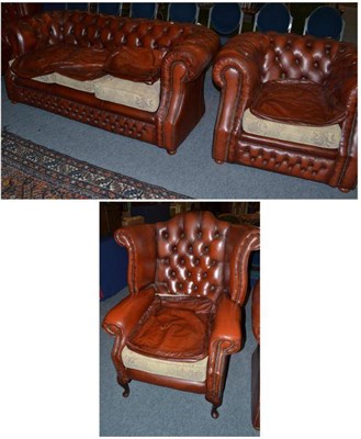 Lot 522 - A red leather upholstered Chesterfield settee, tub shaped armchair and a wing armchair