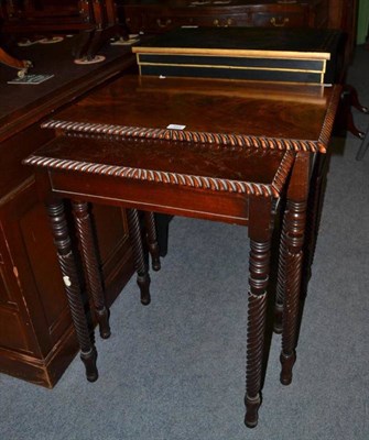 Lot 547 - A Regency nest of two mahogany tables on rope twist legs