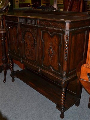 Lot 558 - A walnut three door side cabinet