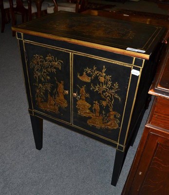 Lot 563 - A Japanese style black lacquered side cabinet