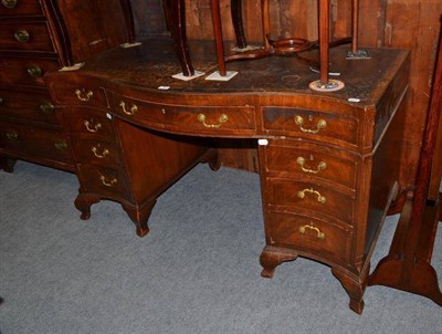 Lot 566 - A Georgian style mahogany serpentine front pedestal desk