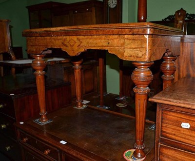 Lot 569 - A Victorian figured walnut fold-over card table