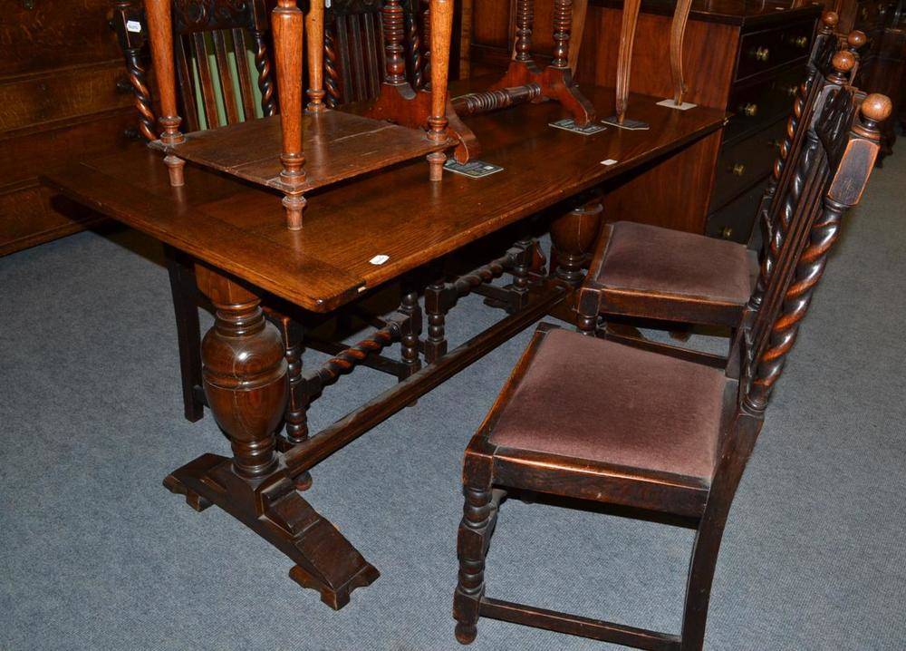 Lot 574 - A small oak refectory table and four lath back chairs