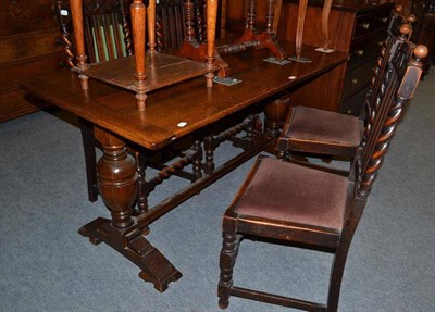 Lot 574 - A small oak refectory table and four lath back chairs