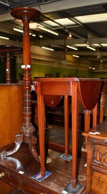 Lot 576 - A small mahogany oval drop leaf table and a torchere