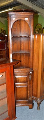 Lot 579 - A small reproduction oak standing corner cupboard