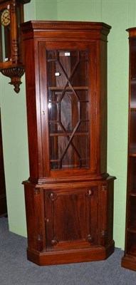 Lot 582 - A reproduction mahogany standing corner cupboard