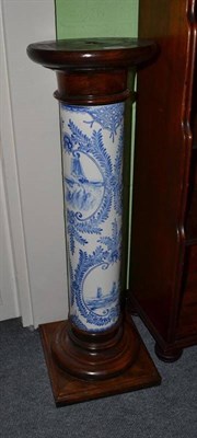 Lot 599 - A blue and white pottery column pedestal with oak base and top, 88cm high