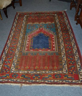 Lot 609 - A Ladik Prayer rug central Anatolia, the indigo field beneath a stepped Mihrab enclosed by...