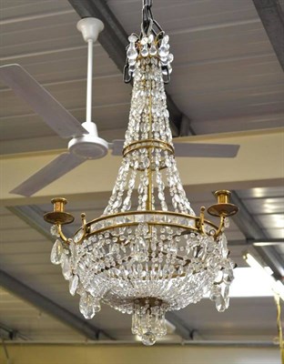 Lot 617 - Large brass chandelier with glass drops and four sconces (and receipt)