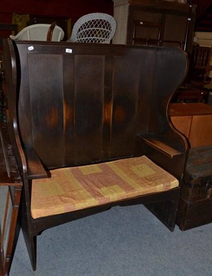 Lot 650 - An oak high wing back settle