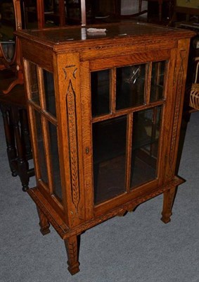 Lot 657 - An oak display cabinet