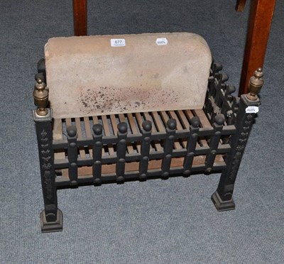 Lot 677 - A cast iron dog grate