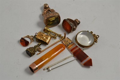 Lot 2 - A magnifying fob, a gold and amber cheroot holder, a silver bar brooch, a segment of mounted banded