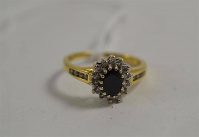 Lot 7 - An 18ct gold sapphire and diamond cluster ring