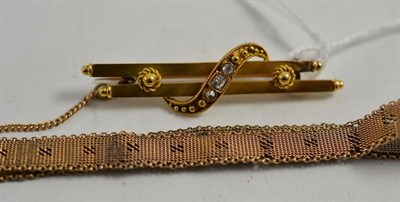 Lot 8 - A diamond set bar and scroll brooch, stamped '15' and a watch bracelet, clasp stamped '9C' (2)