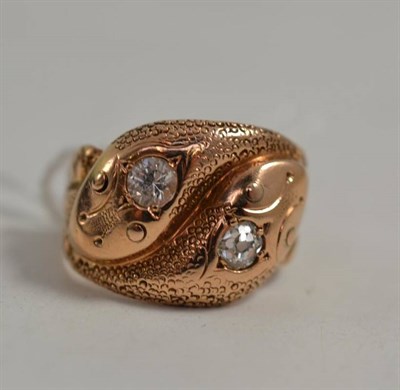 Lot 24 - A 9ct gold double snake head ring set with an old cut diamond and a replacement stone