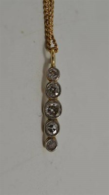 Lot 35 - A diamond five stone drop pendant on a fine curb link chain